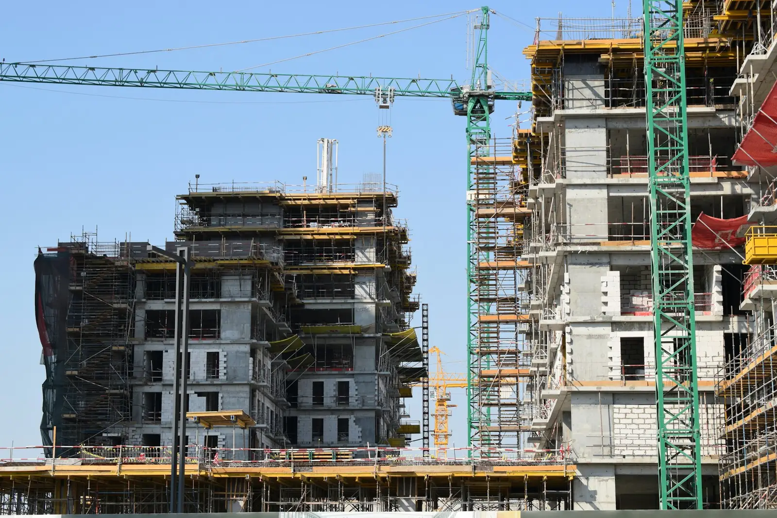 A residential building under construction with cranes